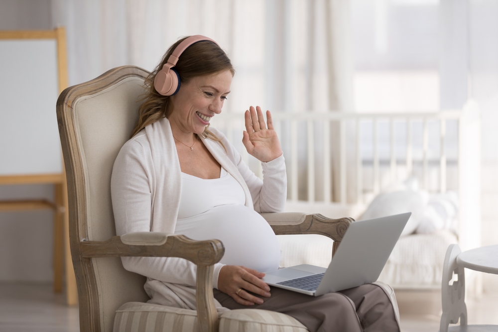 Pregnant lady with laptop getting telehealth services