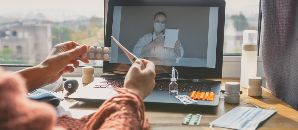 A Lady with with laptop and medicine